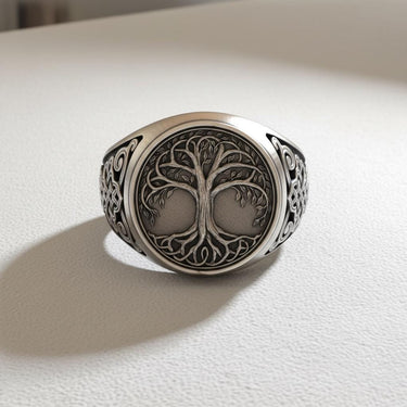 Front view of the Silver Yggdrasil Ring showcasing the intricate Tree of Life design on its face, set on a white surface.