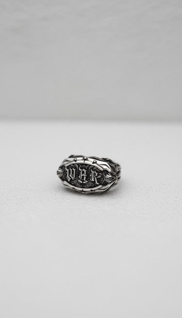 Top-down view of the 925 sterling silver War Ring, showcasing the detailed blackletter typography and ornate band details.