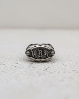 Handcrafted Silver War Ring featuring 'WAR' in a bold gothic font, displayed front-on against a textured light background.