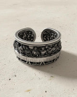 Adjustable 925 silver Last Supper ring with intricate interior filigree pattern, viewed from an angle on a light background.