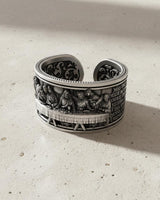 Side profile of the handcrafted Last Supper ring in sterling silver, revealing the engraved scripture along the band's edge.