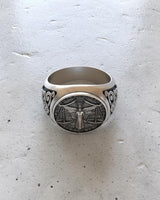 Top-down view of the unisex silver Libra ring, emphasizing the oxidized finish and the circular bezel design on a textured surface.