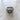 Top-down view of the unisex silver Libra ring, emphasizing the oxidized finish and the circular bezel design on a textured surface.