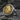 Gold vermeil ancient Egyptian coin ring with side profile of Queen Nefertiti on textured rock surface