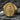 Gold vermeil Miraculous Medal ring with detailed Virgin Mary engraving displayed on dark textured rock