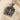 Perspective view of silver Da Vinci Vitruvian Man necklace showing bas-relief details and stone bail