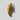 Close-up of the handcrafted wolf fang pendant resting on a textured white surface highlighting its luxurious gold finish