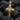 Angled shot of gold vermeil cross pendant highlighting diamond settings and openwork design