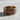 Close-up of the handcrafted red stone band ring on a textured surface, detailing the vibrant square stones and metalwork.