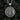 Polished 925 sterling silver Medusa pendant with meander pattern border displayed on textured coal surface