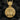 Close-up of orthodox saint medallion showing detailed engraving and Alpha Omega symbols on bail