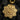 Angled shot of handcrafted silver mandala pendant highlighting detailed relief and floral craftsmanship