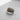 Two-tone silver cross ring with a gold accent emblem and an oxidized, textured band, angled to show detail on a grey background.