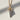 Macro detail of the ice cream cone pendant highlighting the realistic oxidized silver waffle texture and gold swirl