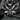 Close-up of 3D sculptural butterfly pendant resting on dark stone highlighting the textured oxidized silver finish