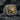 Close-up of premium two-tone lion signet ring resting on dark stone, highlighting the intricate craftsmanship.
