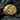 Close-up of the handcrafted ornate signet ring highlighting symmetrical ornamental details on a dark stone surface