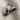 Hugging Arms Ring, oxidized silver, top-down view of clasping hands on linen