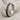 Close-up of the handcrafted oxidized silver twisted band ring resting beautifully on a textured linen surface