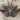 Close-up of oxidized silver butterfly pendant resting on textured fabric showing detailed craftsmanship