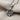 Leaf Twig Pendant, oxidized silver, angled close-up view on fabric