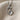 Mother Baby Footprint Pendant, oxidized, front view on textured fabric