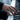 Two-tone military signet ring worn on man's hand playing piano, showcasing the intricate De Oppresso Liber text engraving