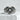 Close-up angled view of the oxidized silver heart keyhole ring resting on a textured stone block highlighting depth