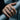 Close-up of the romantic lovers kiss ring worn on a woman's hand gripping a metallic railing outdoors