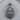 Close-up of orthodox Christian Saint Peter pendant showing detailed face, keys, and Cyrillic text on wood
