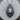 Close-up of the intricately detailed sterling silver crowned lion pendant resting on a natural wood log