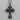 Close-up of the vintage-inspired gothic cross pendant in oxidized silver resting flat on a textured wooden surface