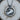 Close-up of the handcrafted oxidized silver Taurus zodiac pendant resting on wood, highlighting the intricate metalwork