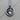 Close-up of the oxidized silver Virgo pendant resting on a wooden surface highlighting intricate metalwork