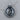 Close-up of oxidized silver sun and moon pendant resting on a natural wood surface highlighting the premium craftsmanship
