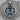Close-up of handcrafted oxidized silver Gemini zodiac pendant showing intricate figures resting on a wooden surface