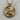 Close-up of the majestic lion mane details on the gold vermeil astrology pendant resting on a natural wood surface