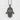 Lotus Eye Hamsa Hand Pendant in oxidized silver, front view against textured wall
