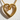 Close-up of the polished gold vermeil infinity heart pendant casting a sharp shadow on a textured white surface