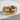 Detailed top view of the modern shield ring resting on a stone surface highlighting the symmetrical art deco engraving