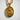 Gold vermeil Saint Genevieve Christian medallion pendant resting on a white textured surface under bright natural sunlight