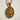 Close-up of the Saint Sebastian pendant in gold vermeil over 925 sterling silver resting on a flat surface