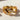 Close-up of a premium infinity heart ring with brilliant stones gleaming warmly under natural sunlight.