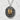 Front view of oxidized silver Japanese lantern pendant resting against a highly textured white stone background