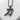 Close-up of the katana kanji pendant resting on a white stone slab highlighting polished raised edges