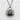 Salmon Onigiri Pendant, oxidized silver, front view on textured surface