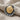 Detailed macro view of the radiating ridges and gold center of the statement scallop shell earring for women