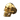 Gold vermeil skull ring with high polish finish displayed on dark textured rock background