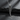 High polish silver angel wing pendant for men and women displayed on textured slate surface