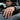 Model wearing handcrafted oxidized silver moonstone scale ring on finger resting against black car door